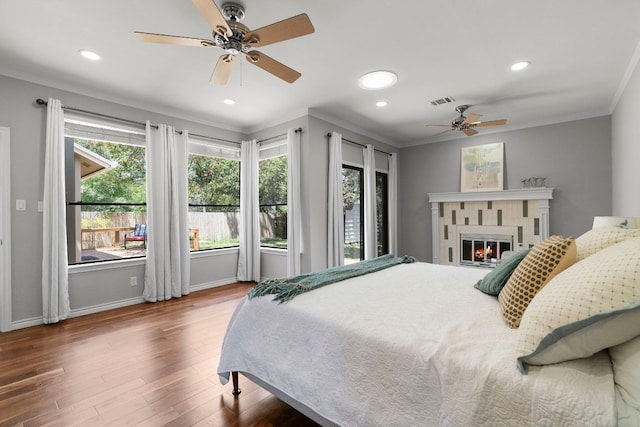 5812 Abilene Trl, Austin, TX 78749 - bedroom with ornamental molding, wood finished floors, recessed lighting, a tile fireplace, and a ceiling fan