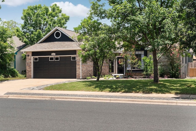 5812 Abilene Trl, Austin, TX 78749 - view of front of home with an attached garage, a front lawn, concrete driveway, brick siding, and roof with shingles