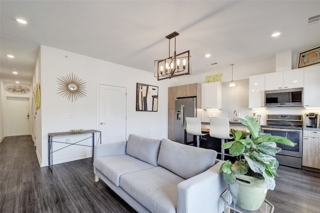 4361 S Congress Ave Unit 126, Austin, TX 78745 - living room with dark wood-style floors, a chandelier, and recessed lighting