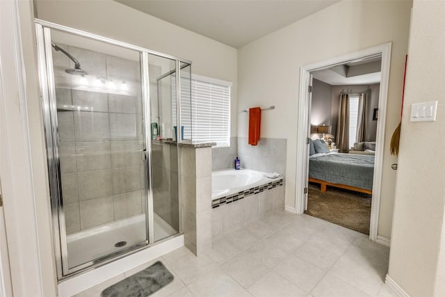 544 Blossom Valley Strm, Buda, TX 78610 - full bathroom with ensuite bath, a bath, a stall shower, and tile patterned floors