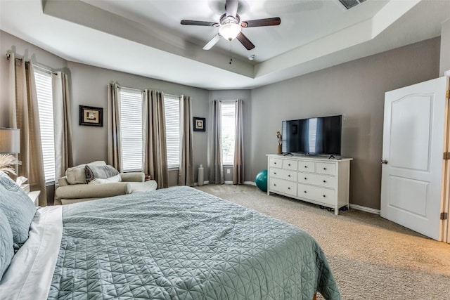 544 Blossom Valley Strm, Buda, TX 78610 - bedroom featuring a tray ceiling, light carpet, and ceiling fan