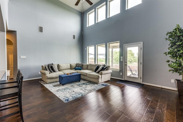 544 Blossom Valley Strm, Buda, TX 78610 - living area featuring ceiling fan, a towering ceiling, arched walkways, and hardwood / wood-style flooring