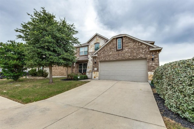 544 Blossom Valley Strm, Buda, TX 78610 - traditional home with brick siding, concrete driveway, an attached garage, a front lawn, and stone siding