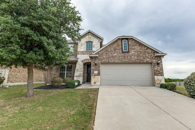 544 Blossom Valley Strm, Buda, TX 78610 - french country inspired facade with driveway, a garage, brick siding, a front lawn, and stone siding