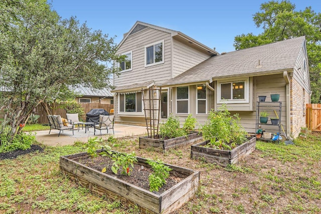 7702 Kincheon Ct, Austin, TX 78749 - rear view of house with a garden, a patio, and roof with shingles