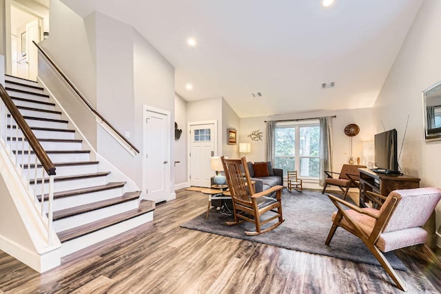 7702 Kincheon Ct, Austin, TX 78749 - living area featuring wood finished floors, stairway, recessed lighting, and high vaulted ceiling
