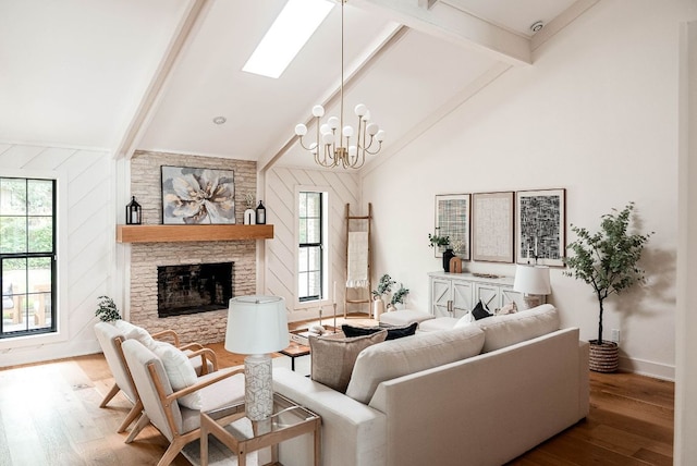 10501 Ronwood Dr, Austin, TX 78750 - living room with beam ceiling, wood finished floors, a stone fireplace, a chandelier, and high vaulted ceiling