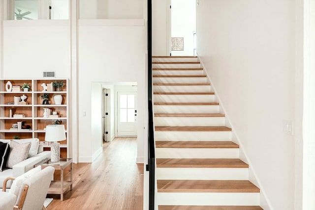 10501 Ronwood Dr, Austin, TX 78750 - staircase featuring wood finished floors and a high ceiling