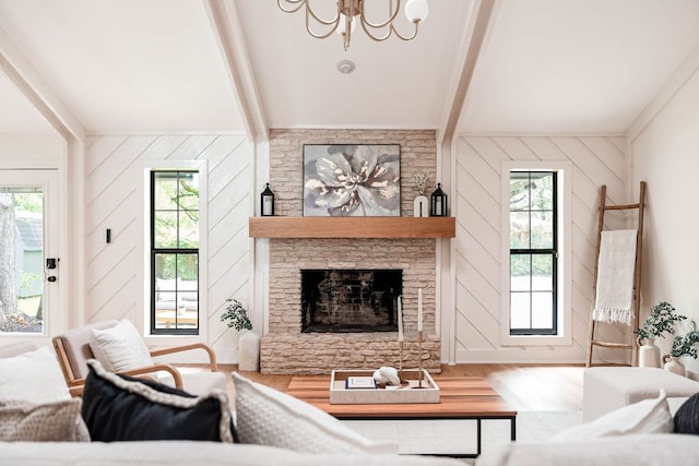 10501 Ronwood Dr, Austin, TX 78750 - living area with beam ceiling, wood finished floors, a chandelier, plenty of natural light, and a stone fireplace