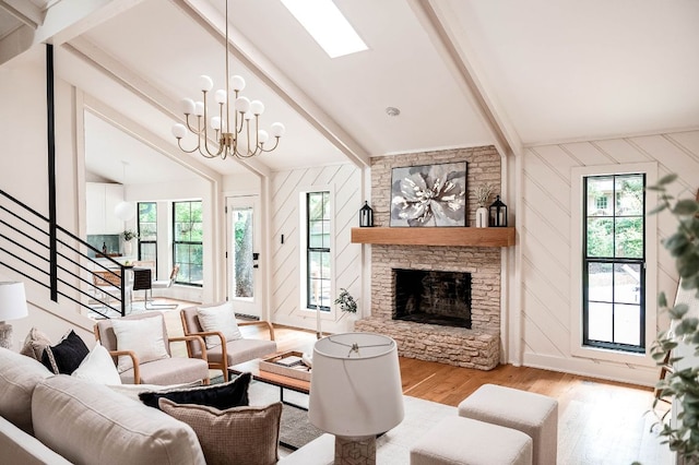 10501 Ronwood Dr, Austin, TX 78750 - living area with wood finished floors, plenty of natural light, a chandelier, and a stone fireplace