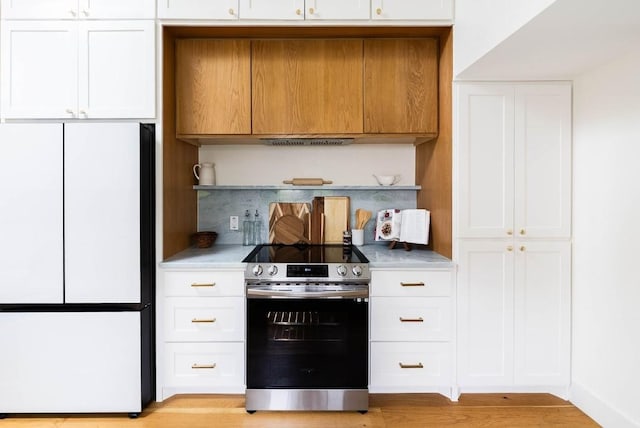 10501 Ronwood Dr, Austin, TX 78750 - kitchen with white refrigerator, electric stove, open shelves, light countertops, and white cabinetry