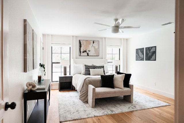10501 Ronwood Dr, Austin, TX 78750 - bedroom featuring multiple windows, light wood finished floors, and ceiling fan