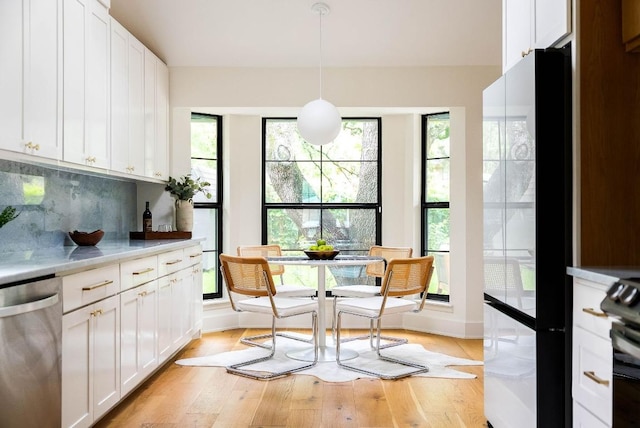 10501 Ronwood Dr, Austin, TX 78750 - kitchen featuring dishwasher, light countertops, decorative backsplash, and white cabinetry
