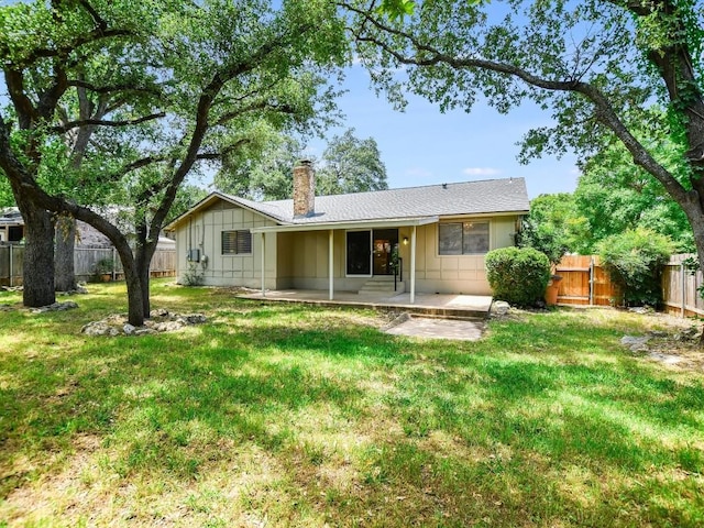 11303 Toledo Dr, Austin, TX 78759 - back of house featuring board and batten siding, a chimney, a patio area, a fenced backyard, and a gate
