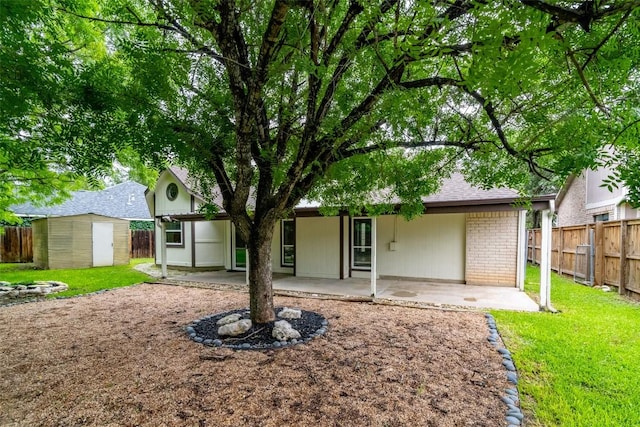 2306 Susan Ln, Leander, TX 78641 - back of property with a patio area, a fenced backyard, a shed, and brick siding