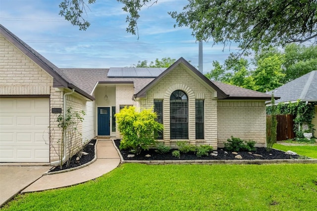 2306 Susan Ln, Leander, TX 78641 - view of front of property featuring brick siding, roof with shingles, solar panels, and a garage