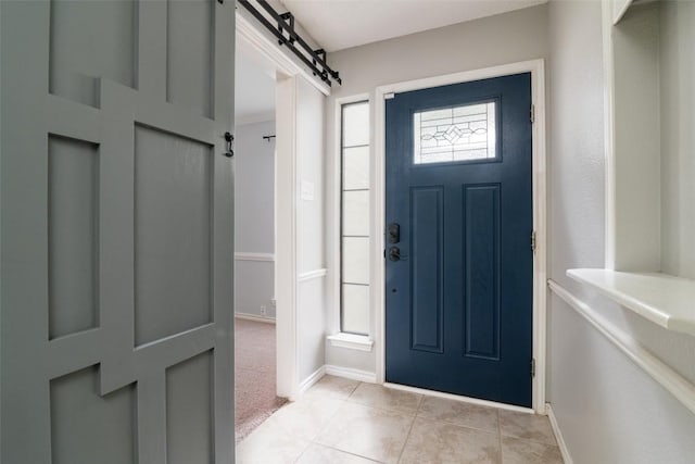 2306 Susan Ln, Leander, TX 78641 - foyer entrance featuring light tile patterned floors, a barn door, and light carpet