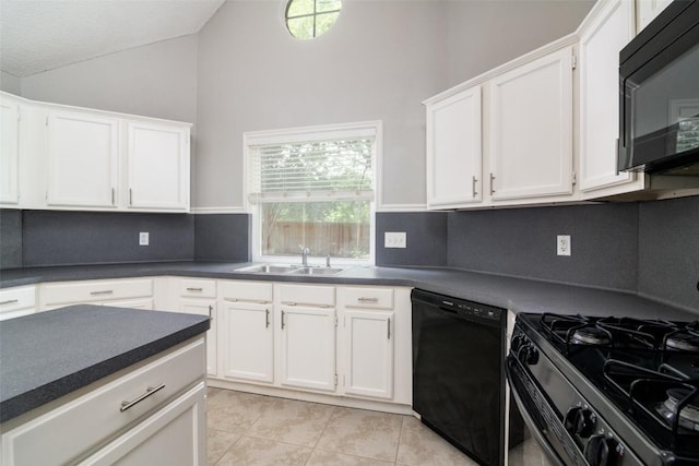 2306 Susan Ln, Leander, TX 78641 - kitchen featuring black appliances, lofted ceiling, dark countertops, light tile patterned floors, and white cabinetry