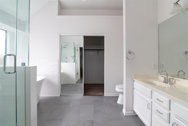 2306 Susan Ln, Leander, TX 78641 - full bath with a shower stall, double vanity, a spacious closet, a soaking tub, and tile patterned flooring