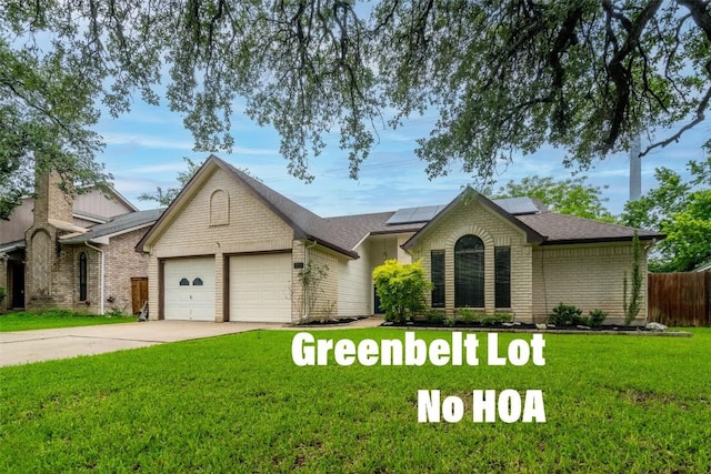 2306 Susan Ln, Leander, TX 78641 - ranch-style home with a garage, roof mounted solar panels, driveway, brick siding, and roof with shingles