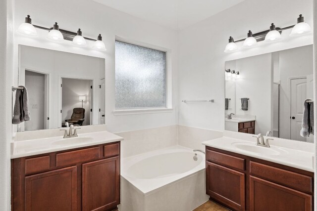 240 Fort Mabry Loop, Georgetown, TX 78628 - bathroom featuring two vanities and a bath