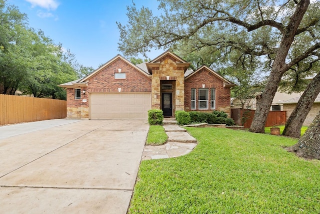 240 Fort Mabry Loop, Georgetown, TX 78628 - traditional-style home with concrete driveway, a garage, stone siding, and brick siding