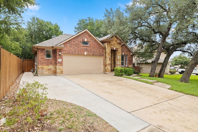 240 Fort Mabry Loop, Georgetown, TX 78628 - traditional home with an attached garage, stone siding, driveway, brick siding, and roof with shingles