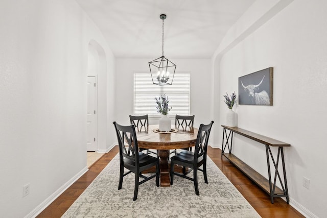 240 Fort Mabry Loop, Georgetown, TX 78628 - dining space with a chandelier, arched walkways, and dark wood-type flooring