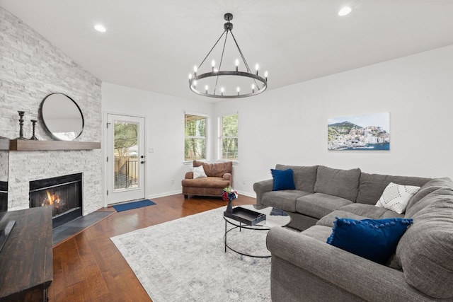 240 Fort Mabry Loop, Georgetown, TX 78628 - living area with a chandelier, dark wood-style flooring, a stone fireplace, and recessed lighting