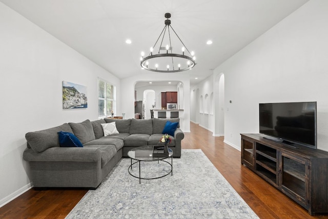 240 Fort Mabry Loop, Georgetown, TX 78628 - living area with arched walkways, dark wood-style flooring, a chandelier, and recessed lighting