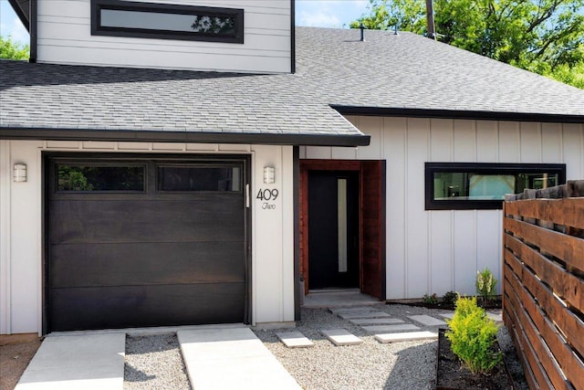 409 W 55th 1/2 St Unit 2, Austin, TX 78751 - view of front of home featuring roof with shingles, board and batten siding, and a garage