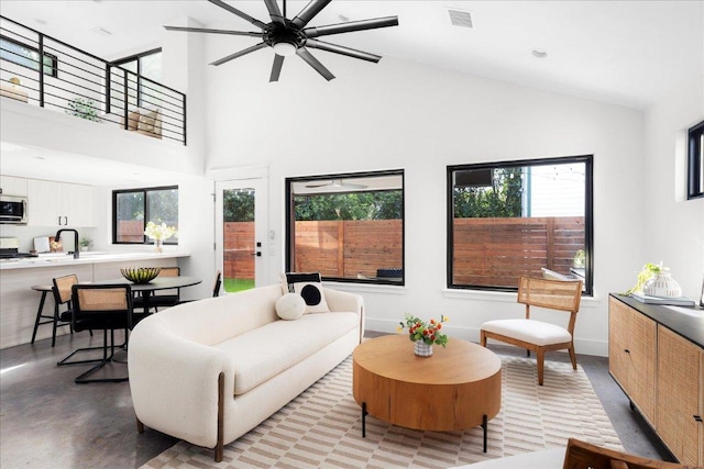 409 W 55th 1/2 St Unit 2, Austin, TX 78751 - living room with healthy amount of natural light, a ceiling fan, high vaulted ceiling, and finished concrete flooring