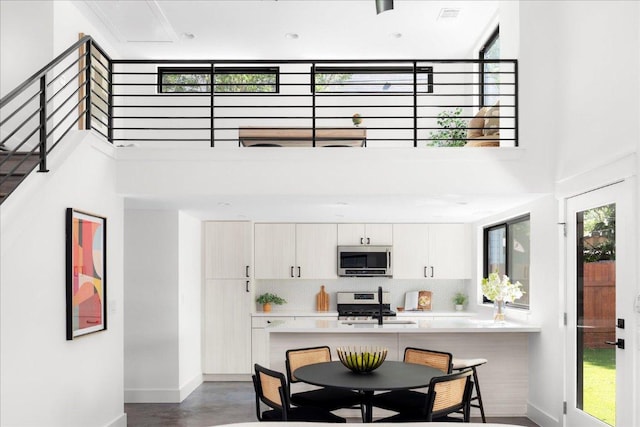 409 W 55th 1/2 St Unit 2, Austin, TX 78751 - dining area with a towering ceiling and stairs
