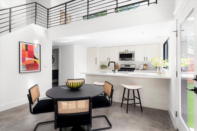 409 W 55th 1/2 St Unit 2, Austin, TX 78751 - dining area featuring finished concrete floors, a high ceiling, and plenty of natural light