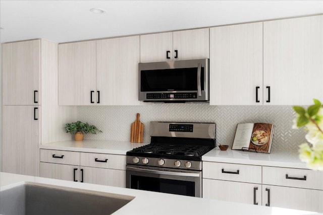 409 W 55th 1/2 St Unit 2, Austin, TX 78751 - kitchen featuring stainless steel appliances, light countertops, and decorative backsplash