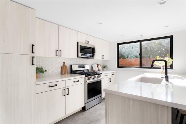 409 W 55th 1/2 St Unit 2, Austin, TX 78751 - kitchen featuring stainless steel appliances, light countertops, decorative backsplash, modern cabinets, and recessed lighting