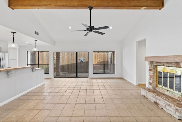 1108 Hi Stirrup Unit 12, Horseshoe Bay, TX 78657 - unfurnished living room with ceiling fan, light tile patterned floors, beam ceiling, a fireplace, and recessed lighting