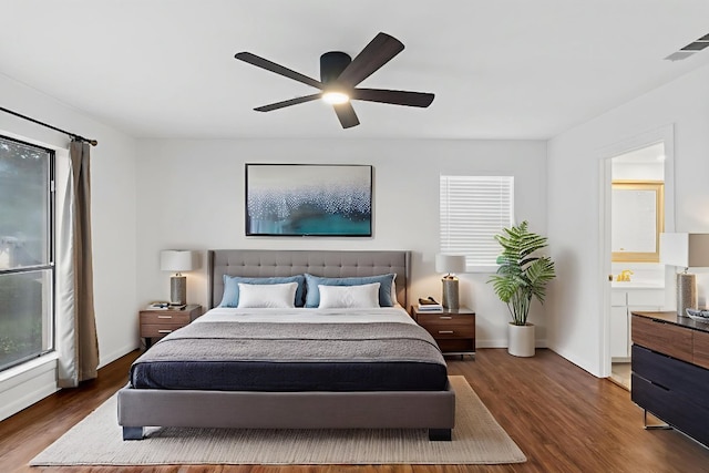 1108 Hi Stirrup Unit 12, Horseshoe Bay, TX 78657 - bedroom with dark wood-type flooring, a ceiling fan, and multiple windows