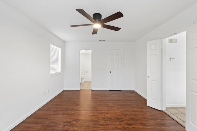 1108 Hi Stirrup Unit 12, Horseshoe Bay, TX 78657 - unfurnished bedroom featuring wood finished floors, ensuite bath, and ceiling fan