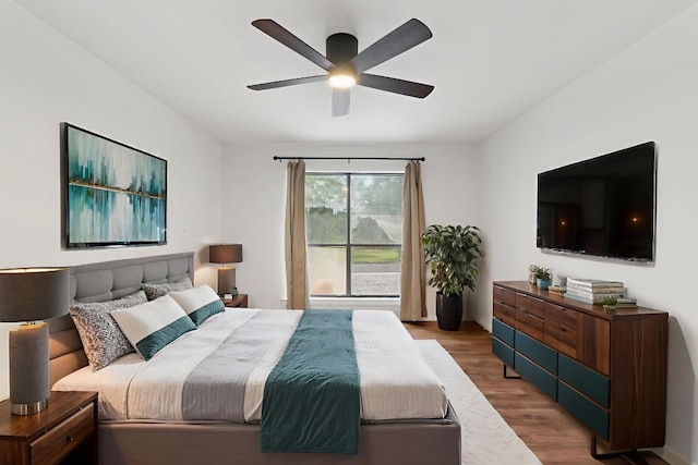 1108 Hi Stirrup Unit 12, Horseshoe Bay, TX 78657 - bedroom with wood finished floors and a ceiling fan