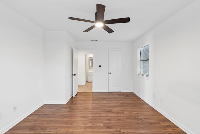 1108 Hi Stirrup Unit 12, Horseshoe Bay, TX 78657 - empty room with ceiling fan and wood finished floors
