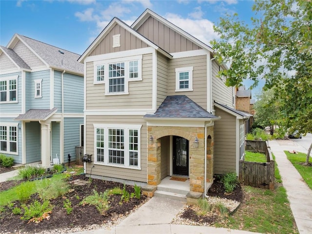 4001 Teaff St, Austin, TX 78723 - view of front of house with board and batten siding, a shingled roof, and stone siding