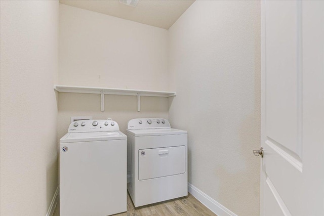18211 Winnow Way, Pflugerville, TX 78660 - washroom featuring separate washer and dryer and light wood-type flooring