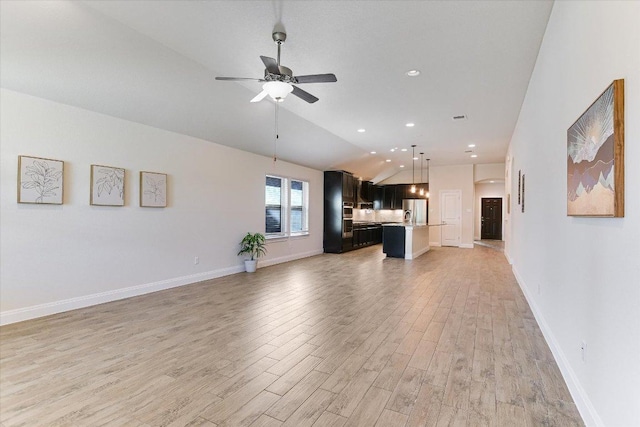 18211 Winnow Way, Pflugerville, TX 78660 - unfurnished living room with light wood-type flooring, a ceiling fan, vaulted ceiling, and recessed lighting