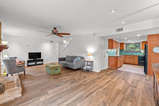 4304 Adelphi Ln, Austin, TX 78727 - living area with light wood finished floors, ceiling fan, and recessed lighting