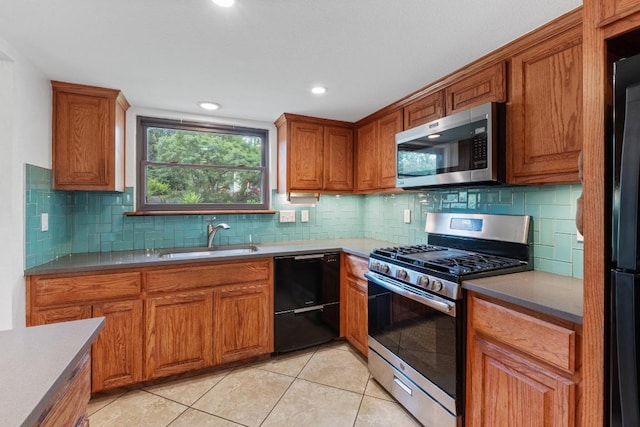 4304 Adelphi Ln, Austin, TX 78727 - kitchen with black appliances, brown cabinetry, light tile patterned flooring, and recessed lighting