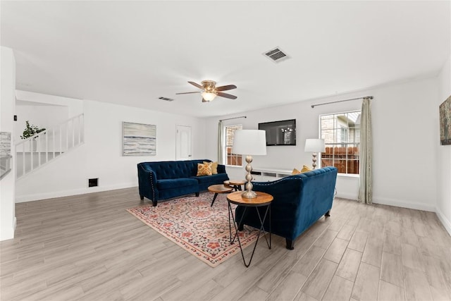 4410 Cisco Valley Dr, Round Rock, TX 78664 - living room featuring light wood-type flooring, stairway, and a ceiling fan