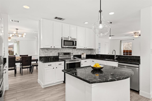 4410 Cisco Valley Dr, Round Rock, TX 78664 - kitchen featuring stainless steel appliances, white cabinetry, decorative backsplash, hanging light fixtures, and recessed lighting