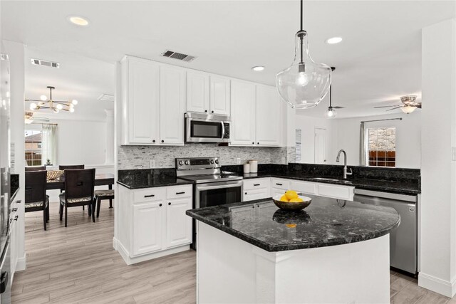 4410 Cisco Valley Dr, Round Rock, TX 78664 - kitchen with appliances with stainless steel finishes, white cabinets, tasteful backsplash, pendant lighting, and recessed lighting