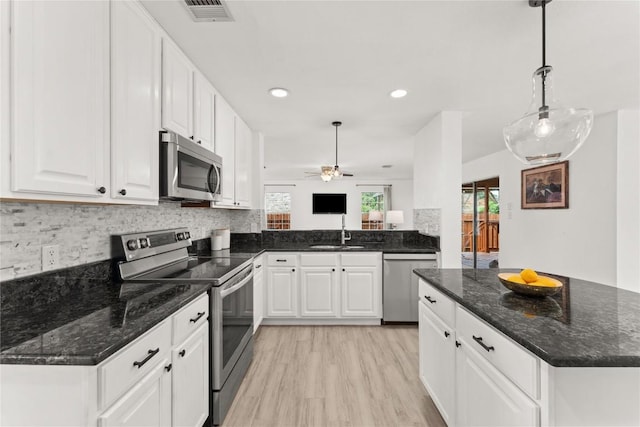 4410 Cisco Valley Dr, Round Rock, TX 78664 - kitchen featuring appliances with stainless steel finishes, plenty of natural light, a ceiling fan, white cabinets, and recessed lighting